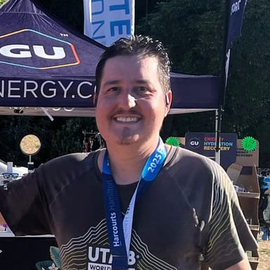 Matheus Castro, smiling with a race medal after a half marathon